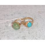 A 9CT YELLOW GOLD RING inset with an oval cabochon turquoise and one other similar ring