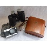 A PAIR OF BINOCULARS in leather cases and a camera (2)