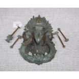 AN ELABORATE DOOR KNOCKER, the scrolling foliate cast knocker suspended from a bird's beak