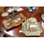 A VICTORIAN BRASS AND GLASS INKWELL ON STAND and a set of postal scales (2)