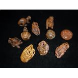 A COLLECTION OF VARIOUS JAPANESE CARVED WOOD NETSUKE including dragons and other animals and