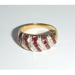 AN 18CT YELLOW GOLD DRESS RING with red and clear stones in a pavé setting