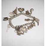 A SILVER CHARM BRACELET with various charms