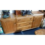 ERCOL: A PALE ELM SIDEBOARD with fitted central cutlery drawer, 61" wide