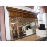 A REPRODUCTION GEORGE III STYLE GILT FRAMED OVERMANTLE MIRROR with swag and tied ribbon