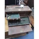 A VINTAGE TOOL CHEST containing fitted drawers with a collection of smaller tools