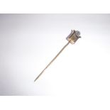 A 19TH CENTURY YELLOW METAL STICK-PIN, set with a hardstone, a flower and neo-classical motifs