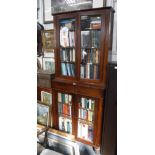A 19TH CENTURY MAHOGANY BOOKCASE with glazed upper and lower sections and central frieze drawer, 33"