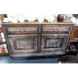 AN EDWARDIAN OAK SIDEBOARD with carved decoration and spurious applied date '1707' supplied by James
