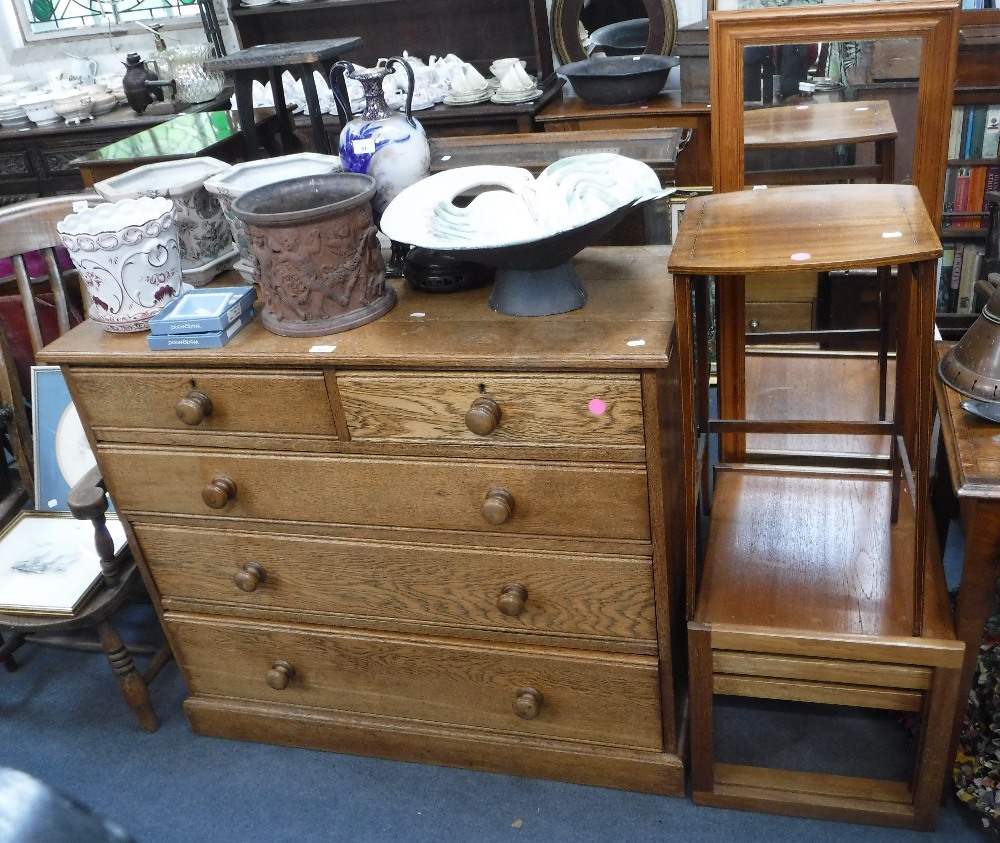 A LIGHT OAK CHEST OF DRAWERS, 42" wide, a nest of three teak tables, a wall mirror and an occasional