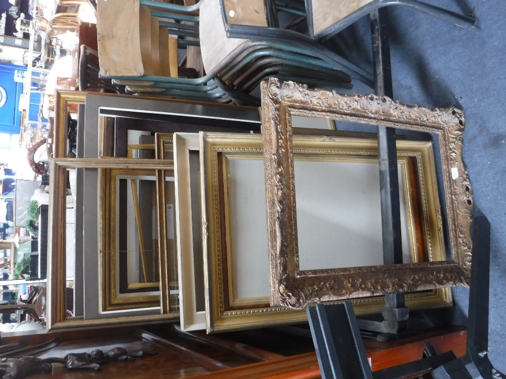 A COLLECTION OF PICTURE FRAMES including gilt examples and a Victorian maple frame