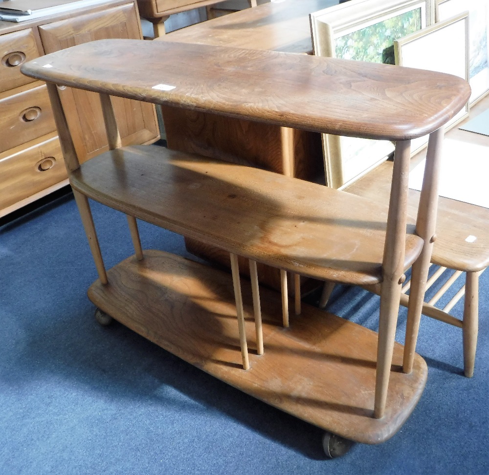 ERCOL: A PALE ELM THREE TIER ROOM DIVIDER on castors, 36" long