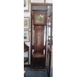 A 20TH CENTURY WALNUT LONGCASE CLOCK incorporating an old eight day movement and carved panel to the