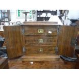 A VICTORIAN WALNUT TABLE CABINET with inlaid decoration, fitted three interior drawers behind a pair