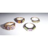 A COLLECTION OF FOUR DRESS RINGS decorated with green, mauve and gold stones on 9ct gold shank