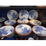 A SET OF ELEVEN JAPANESE PORCELAIN DISHES printed in blue with floral and leaf decoration, impressed
