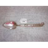A FRENCH SILVER PUDDING SERVER with a pistol-grip handle with engraved foliate decoration,