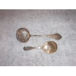 A VICTORIAN SILVER STRAINING SPOON with engraved decoration by George Unite and a Victorian silver