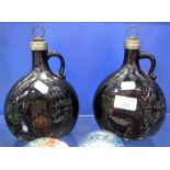 A PAIR OF EARLY VICTORIAN DARK AMBER GLASS SPIRIT FLASKS with silver plated stoppers, 8.5" high