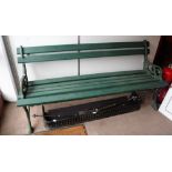 A VICTORIAN CAST-IRON GARDEN BENCH with wooden slats, painted green, 66" long (some older