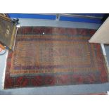 A TRADITIONAL RUSSET GROUND PERSIAN PRAYER RUG, 36" x 55", a small carpet sack and a miniature