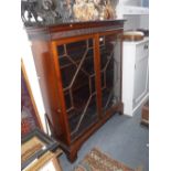 A GEORGE III STYLE GLAZED MAHOGANY BOOKCASE with adjustable shelves, 50" high x 42" wide