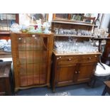 A REPRODUCTION OAK SIDEBOARD with raised shelved back and a walnut glazed display cabinet