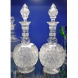 A PAIR OF VICTORIAN CUT-GLASS DECANTERS WITH MATCHING STOPPERS, 11.25" high