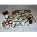 A COLLECTION OF VINTAGE BRACELETS AND BANGLES including examples in white metal, china and wooden