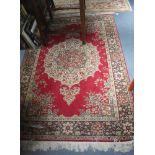 A RED GROUND RUG of Persian design, 55" x 80"