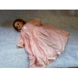 A VICTORIAN S.F.B.J. PARIS PORCELAIN HEAD DOLL with a composite body and wearing a pink dress