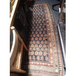 A TRADITIONAL BLUE GROUND PERSIAN RUG with all over geometric decoration, 39" x 90"