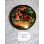 A RUSSIAN PAPIER MACHE AND PAINTED SNUFF BOX with a scene of a man with phoenix bird and horse