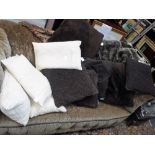 A FAUX-FUR THROW and a collection of contemporary scatter cushions