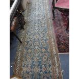 A LARGE BLUE GROUND PERSIAN RUNNER, 40" wide x 147" long
