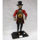 A CAST METAL FIGURE OF A 'CLOCK PEDDLER', with a working movement to his chest, 16" high