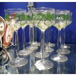 A SET OF ELEVEN ART NOUVEAU GLASSES with green shamrock decoration on tall stems, 7.5" high