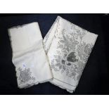 A VINTAGE TABLE CLOTH AND NAPKIN LINEN SET, embroidered with flowers