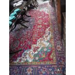 A LARGE RED GROUND PERSIAN DESIGN CARPET, 116" x 152"