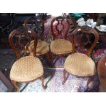 A SET OF FOUR VICTORIAN CARVED WALNUT PARLOUR CHAIRS