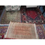 A RED GROUND PERSIAN RUG with geometric decoration, 50" x 76" and two similar rugs (3)