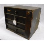 AN EDWARDIAN GREEN LEATHER COVERED FOUR DRAWER TABLE CABINET and two brushes in a similar case