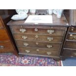 A GEORGE III MAHOGANY BACHELOR CHEST fitted a brushing slide with pierced brass handles and