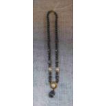 A CULTURED 'BLACK PEARL' NECKLACE with 18ct yellow gold clasp