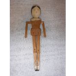 A LATE VICTORIAN/EARLY 20TH CENTURY CARVED WOOD 'DUTCH' PEG DOLL with articulated limbs. 11.75"