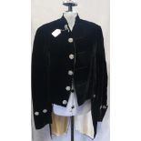 VINTAGE: A BLACK VELVET 'FOOTMAN' STYLE COAT, with metal cut buttons to the front