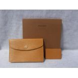 LOUIS VUITTON; A TAN LEATHER CLUTCH BAG IN ORIGINAL BOX, with matching credit card holder