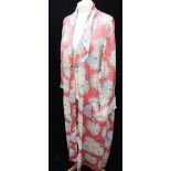 A PINK FLORAL FULL LENGTH HOUSECOAT, circa 1950