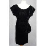 WISHICK & WEBBER: A VINTAGE BLACK VELVET EVENING DRESS with swagged and rouched design, gathered