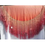 A VINTAGE SILK PIANO SHAWL in peach bleeding through to dusky pink, with long fringing, circa 44"